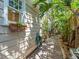Exterior home view featuring brick pathway and mature tropical landscaping at 125 29Th N St, St Petersburg, FL 33713