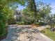 Charming two-story home with a paved driveway, fenced yard, and mature trees at 125 29Th N St, St Petersburg, FL 33713