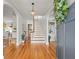 Inviting foyer with hardwood floors, a staircase, and an open doorway to the living area at 125 29Th N St, St Petersburg, FL 33713