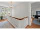 Bright hallway features a chandelier, wood floors, and white railing with natural wood trim at 125 29Th N St, St Petersburg, FL 33713