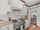 Kitchen features white cabinets, granite countertops, a gas range, and stainless steel appliances at 125 29Th N St, St Petersburg, FL 33713