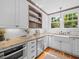 Bright kitchen featuring white cabinetry, granite countertops, and stainless steel appliances at 125 29Th N St, St Petersburg, FL 33713