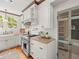 Bright kitchen features stainless steel stove, granite countertops, subway tile, and bright, natural light from garden window at 125 29Th N St, St Petersburg, FL 33713