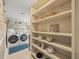 Bright Laundry Room includes shelving and front load washer and dryer at 125 29Th N St, St Petersburg, FL 33713