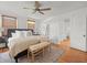 Spacious primary bedroom with hardwood floors, a ceiling fan, and a bench seat at 125 29Th N St, St Petersburg, FL 33713