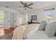 Spacious primary bedroom with hardwood floors, a ceiling fan, and multiple windows at 125 29Th N St, St Petersburg, FL 33713