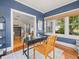 Home office featuring a dark desk, blue walls, and view to the living room at 125 29Th N St, St Petersburg, FL 33713