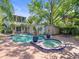 Backyard pool and spa with mature shade trees and seating area at 125 29Th N St, St Petersburg, FL 33713