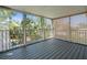Screened-in porch boasts wood flooring and views of the lush backyard and pool at 125 29Th N St, St Petersburg, FL 33713