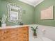 Stylish powder room features a decorative mirror, ornate vanity, and wainscoting at 125 29Th N St, St Petersburg, FL 33713