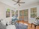Light-filled sun room with ceiling fan, wood floors, and view of the outdoor pool at 125 29Th N St, St Petersburg, FL 33713
