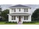 Charming two-story home featuring a classic white exterior, inviting front porch, and beautifully manicured landscaping at 1521 21St N Ave, St Petersburg, FL 33704