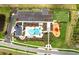 Aerial view of community amenities featuring a pool, playground, dog park, and parking lot at 17122 Moonflower Dr, Venice, FL 34293