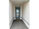 Inviting entryway with a stylish blue front door and neutral colored walls at 17122 Moonflower Dr, Venice, FL 34293