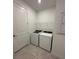 Convenient laundry room featuring new washer, dryer, tile floors, and shelving at 17122 Moonflower Dr, Venice, FL 34293