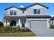 Charming two-story home featuring a two-car garage and a beautifully landscaped front yard at 17146 Moonflower Dr, Venice, FL 34293