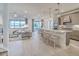 Open kitchen with a large island, pendant lighting, and views of the living room and outdoor scenery at 17146 Moonflower Dr, Venice, FL 34293