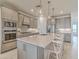 Contemporary kitchen featuring an island with bar stools, stainless steel appliances, and stylish backsplash at 17146 Moonflower Dr, Venice, FL 34293