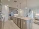 Bright kitchen featuring stainless steel appliances, center island, and open layout into the living area at 17146 Moonflower Dr, Venice, FL 34293