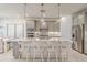 Modern kitchen with stainless steel appliances, central island, pendant lighting and breakfast bar at 17146 Moonflower Dr, Venice, FL 34293