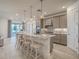 Spacious kitchen with a large center island, pendant lights, and stainless steel appliances at 17146 Moonflower Dr, Venice, FL 34293