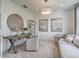 Bright office space with modern decor, a wooden desk, and comfortable seating area at 17146 Moonflower Dr, Venice, FL 34293