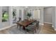 Dining room with a wooden table, seating for four, and natural light from the patio doors at 17466 Nokota Ave, Hudson, FL 34667