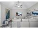 Living room with comfortable sofa, vaulted ceilings, ceiling fan, and mounted television at 17466 Nokota Ave, Hudson, FL 34667