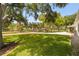 Expansive backyard with lush green grass and mature trees at 1800 Mound S Pl, St Petersburg, FL 33712