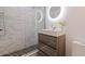 Modern bathroom with walk-in shower, stylish vanity, and lighted round mirror at 1800 Mound S Pl, St Petersburg, FL 33712