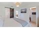 Stylish bedroom featuring a barn door to the bathroom and a mounted television for added convenience at 1800 Mound S Pl, St Petersburg, FL 33712