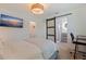 Cozy bedroom featuring a view to the en-suite bathroom, closet, and mounted TV at 1800 Mound S Pl, St Petersburg, FL 33712