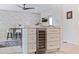Kitchen island with wine cooler and seating, adjacent to the dining area with stylish stone accent wall at 1800 Mound S Pl, St Petersburg, FL 33712