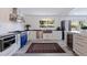 Modern kitchen with custom blue oven, stainless steel appliances, and white cabinetry at 1800 Mound S Pl, St Petersburg, FL 33712