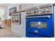 Close-up of modern kitchen appliances including a custom blue oven and stainless steel microwave at 1800 Mound S Pl, St Petersburg, FL 33712