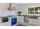 Well-appointed kitchen featuring sleek appliances, custom range, and a view to the backyard at 1800 Mound S Pl, St Petersburg, FL 33712