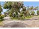 The property features a well-maintained yard with a mix of trees and open space at 1800 Mound S Pl, St Petersburg, FL 33712
