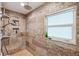 Modern shower features stylish tile work, a rain shower head, and convenient built-in niche shelves at 1939 Hawaii Ne Ave, St Petersburg, FL 33703