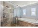 Modern bathroom featuring glass enclosed shower and large soaking tub at 1939 Hawaii Ne Ave, St Petersburg, FL 33703