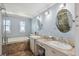 Bathroom featuring double sinks, vanity, tub, and neutral paint at 1939 Hawaii Ne Ave, St Petersburg, FL 33703