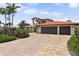 Inviting front exterior featuring a paved driveway and a well-kept lawn, complete with mature palm trees at 1939 Hawaii Ne Ave, St Petersburg, FL 33703