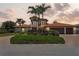 Beautiful two-story home showcasing well-maintained landscaping, a tile roof, and an attached garage at 1939 Hawaii Ne Ave, St Petersburg, FL 33703