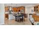 Kitchen features wooden cabinets, stainless steel appliances, a mosaic backsplash, and an island with seating at 1939 Hawaii Ne Ave, St Petersburg, FL 33703