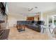 Open living room showcases a large sectional sofa, tile flooring, and access to the patio and pool area at 1939 Hawaii Ne Ave, St Petersburg, FL 33703