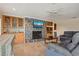 Living room features a fireplace with stone surround, built-in cabinets, and comfortable reclining sofas at 1939 Hawaii Ne Ave, St Petersburg, FL 33703