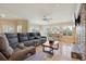 Spacious living room features large windows, tile floors, a stone fireplace, and a comfortable sectional sofa at 1939 Hawaii Ne Ave, St Petersburg, FL 33703