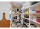 Walk-in pantry with multiple shelves for food storage, and a tile floor at 1939 Hawaii Ne Ave, St Petersburg, FL 33703