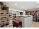 Spacious walk-in closet includes an island, built-in shelving and drawers, and hanging rods for ample storage at 1939 Hawaii Ne Ave, St Petersburg, FL 33703