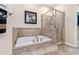 Well-appointed bathroom featuring a soaking tub, a glass-enclosed shower, and stylish tile work at 20053 Heritage Point Dr, Tampa, FL 33647