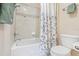 Bathroom featuring a white tub with shower and a toilet with classic finishes at 20053 Heritage Point Dr, Tampa, FL 33647